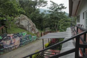 a balcony with a mural on the side of a building at HOTEL LA SELVA Reserva in La Vega