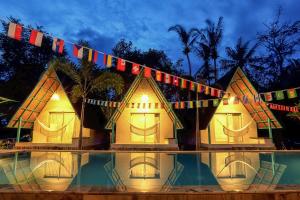 una representación de una casa por la noche con luces en Makarma Resort Lombok en Senggigi 