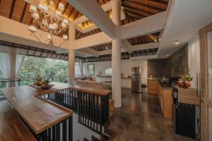 cocina de planta abierta y sala de estar con techo grande en La-Meli Villas Ubud, en Ubud