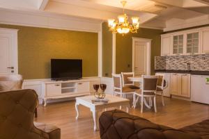 a living room with a table and a tv at Yildiz Life Hotel in Trabzon