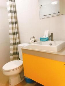 a bathroom with a white toilet and a sink at Baan Ton Chan in Chao Lao Beach