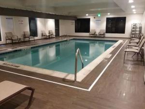 a large swimming pool in a hotel room at Comfort Suites Denver International Airport in Denver