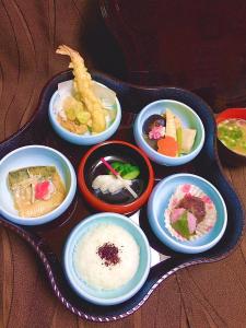 a tray filled with different types of food in bowls at Hotel Lumiere Gotenba (Adult Only) in Gotemba