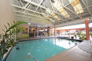 a large indoor swimming pool in a building at Parkside Motel Ayr in Ayr