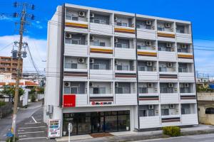 an apartment building on a city street at Mr. Kinjo in Ishikawa Inter in Uruma