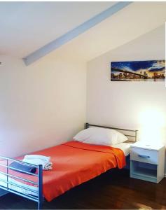 a bedroom with a bed with an orange blanket at David 3 in Pula