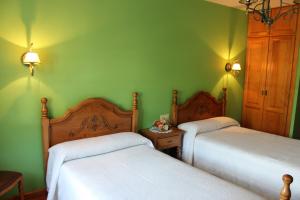 A bed or beds in a room at Posada Sobrevilla