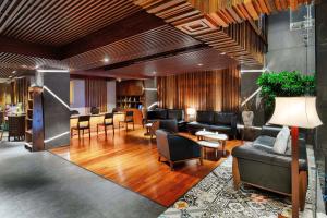 a lobby with couches and chairs and a table at Silverland Sakyo Hotel in Ho Chi Minh City