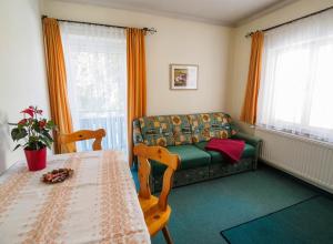 a living room with a couch and a table at Haus Winkler in Filzmoos