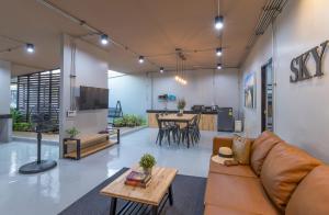 a living room with a couch and a table at Otter House in Krabi