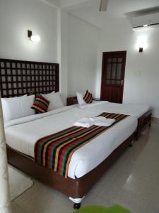 a bedroom with a large bed in a room at Otha Shy Airport Transit Hotel in Katunayaka