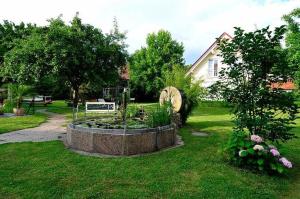 a garden with a fountain in the middle of a yard at Hotel KRONE Kressbronn am Bodensee in Kressbronn am Bodensee