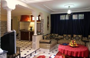 a living room with a couch and a table at Palais Dar Ouladna in Marrakesh