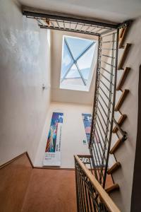 a room with a staircase and a window at Hotel Kent in Rome