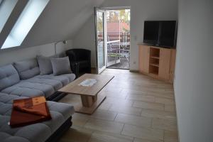 a living room with a couch and a table at Appartement Dachgeschoss in Schlepzig