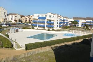 a large swimming pool in front of a building at APPT T3 Rêve d'Océan les pieds dans l'eau in Lacanau