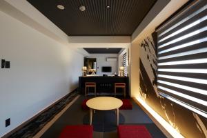 a room with a table and chairs and a desk at Rinn Kamiebisu in Kyoto