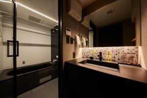 a bathroom with a sink and a mirror at Rinn Kamiebisu in Kyoto