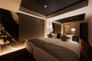 a bedroom with a large bed with a large window at Rinn Kamiebisu in Kyoto +44 photos