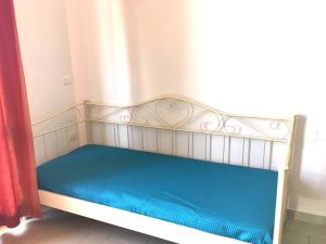 a bed in a room with a blue mattress at Apartment Eva in Tergu