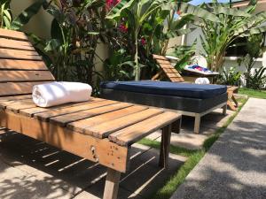 two wooden benches with a mattress on top of them at Maoritsio Garden Studios in Santa Teresa Beach