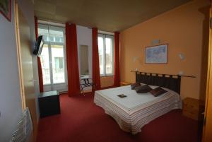 a bedroom with a bed in a room with windows at Fasthotel Pau-Centre HOTEL ADOUR in Pau