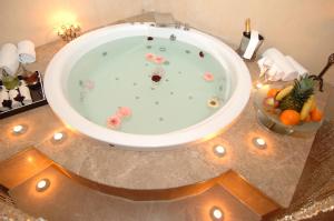 a bathroom with a bath tub with flowers in it at Grand Ankara Hotel Convention Center in Ankara