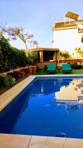 a swimming pool in front of a house at Casa Alameda in Fuengirola