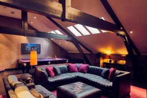 a living room with a couch and a pool table at Malmaison Belfast in Belfast