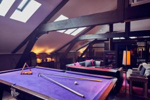 a room with a pool table with bats on it at Malmaison Belfast in Belfast