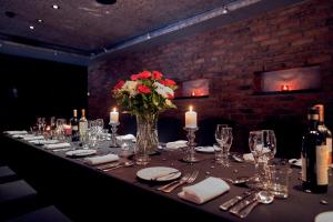 a long table with a vase of flowers and candles at Malmaison Belfast in Belfast +65 photos