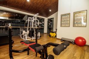 a fitness room with a gym with weights and machines at Clove Transit Hotel in Kotugoda