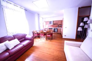 a living room with a couch and a table and chairs at 1Dest - City Heart in Riva del Garda