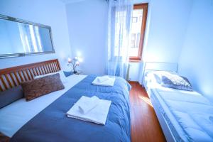 a bedroom with two beds with towels on them at City Heart in Riva del Garda