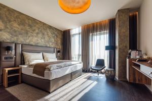 a bedroom with a bed and a large window at NUTREND World in Olomouc