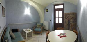 a living room with a couch and a table at B&B Dolce Caraglio in Caraglio