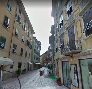 an empty street in a city with buildings at 1Dest - City Heart in Riva del Garda