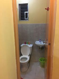 a bathroom with a toilet and a sink at Pines Mansion 2 Homestay for Rent in Cash with 30 percent Advance Payment to Confirm in Butuan +31 photos