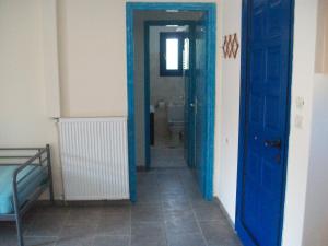 a hallway with blue doors in a room at Serifos Palace in Livadakia