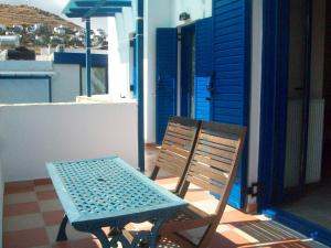 a blue table and chair sitting on a balcony at Serifos Palace in Livadakia
