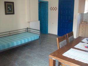 a room with a bed and a table and a dining room at Serifos Palace in Livadakia