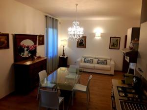 a living room with a glass table and a couch at Suite Umberto I in Assisi