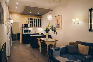 a kitchen and living room with a couch and a table at Sally Port City Pads in Valletta
