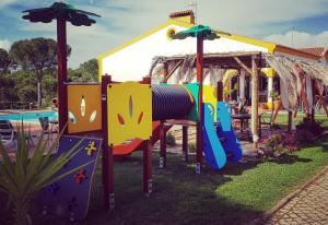 a playground in a park with a slide at Herdade Do Rio Torto in Portel