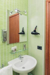 a bathroom with a sink and a mirror at Palazzo Carafa della Spina in Naples