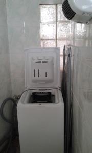 a washer and dryer in a bathroom with a window at La maison D'Orée in Polignac