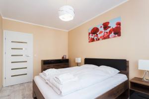 Posteľ alebo postele v izbe v ubytovaní Apartments Kraków Zablocie by Noclegi Renters
