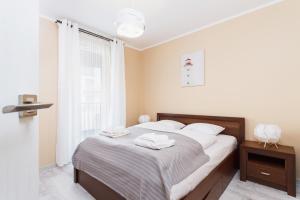 Posteľ alebo postele v izbe v ubytovaní Apartments Kraków Zablocie by Noclegi Renters