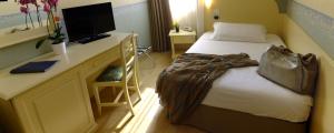 Ένα ή περισσότερα κρεβάτια σε δωμάτιο στο Hotel Ambra