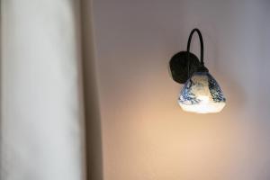 a light hanging on a wall with at Androulakis Apartments in Gerani